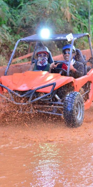 Tourists riding a buggy through a muddy trail in Punta Cana